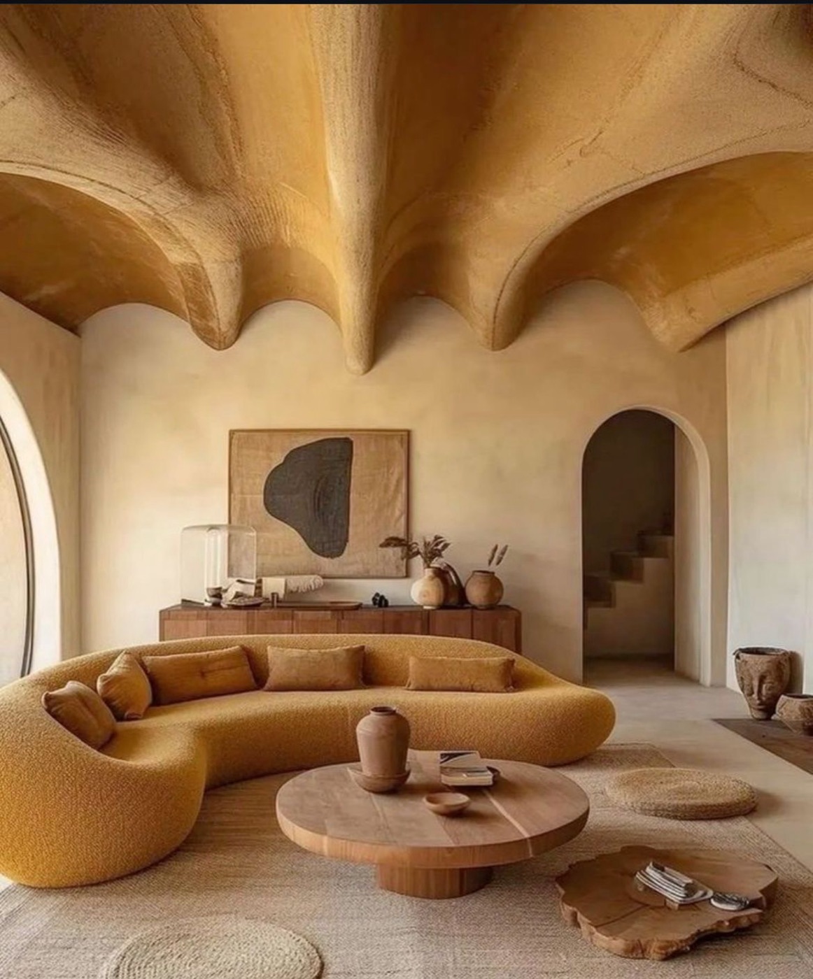 Curved gold sofa under sculptural vaulted ceiling